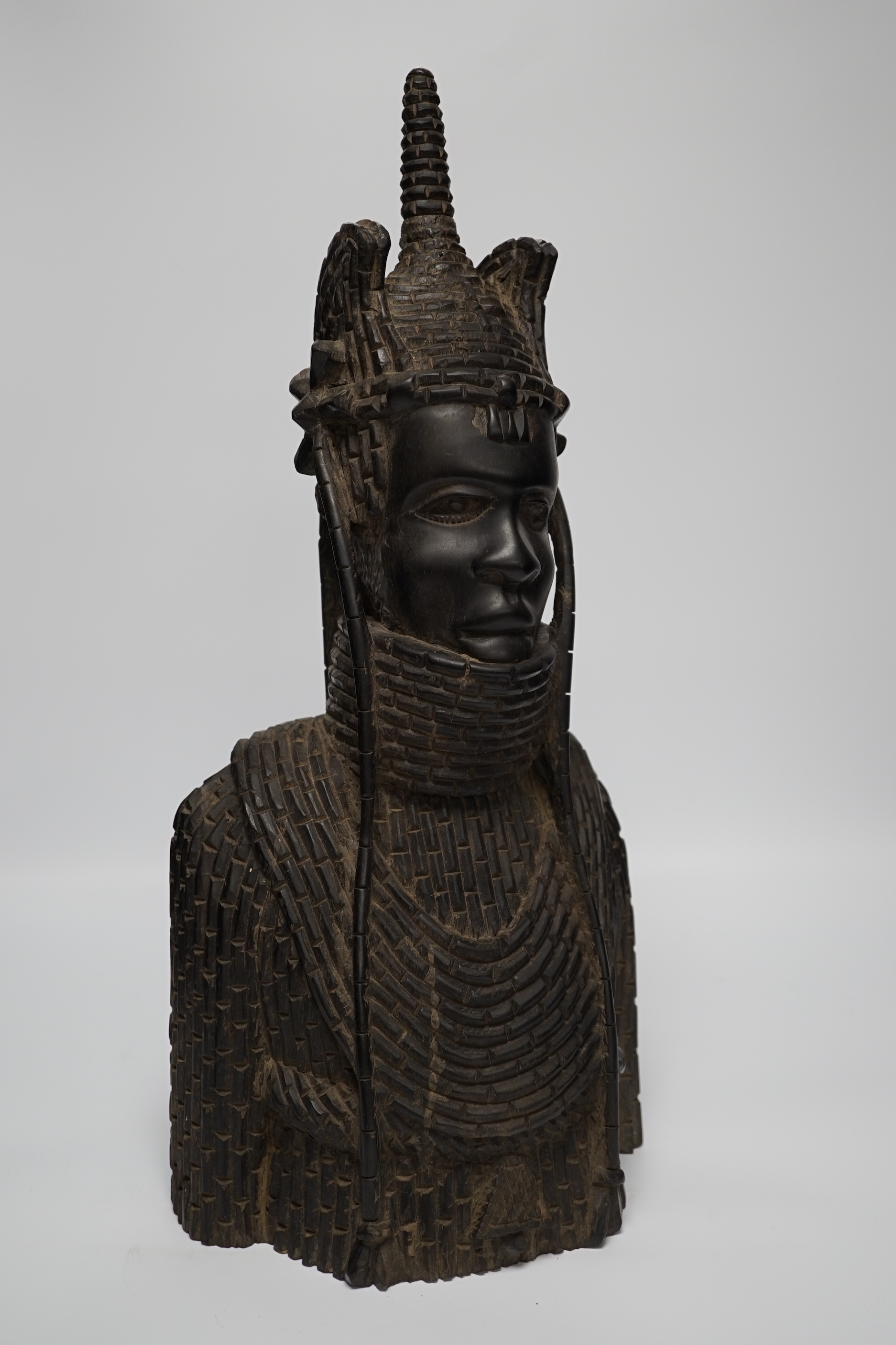 A heavy African ebony carved bust of a warrior, in Benin style, 48cm high